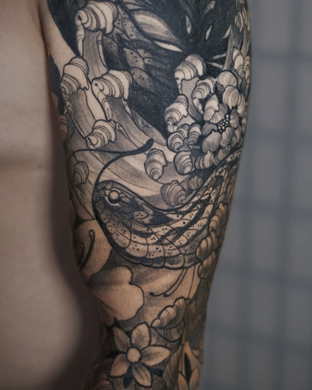 Intricate Japanese koi with waves and peony blossoms