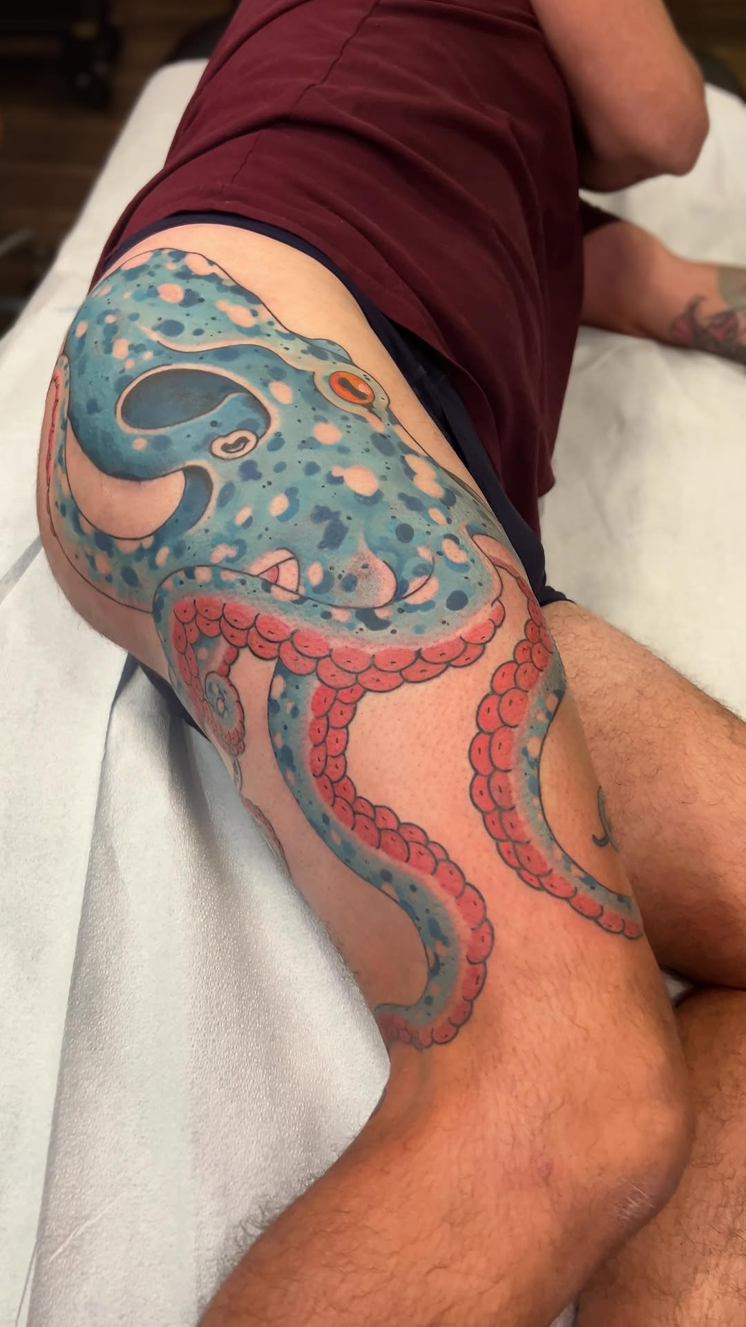 Playful blue octopus tattoo with pink suction cups