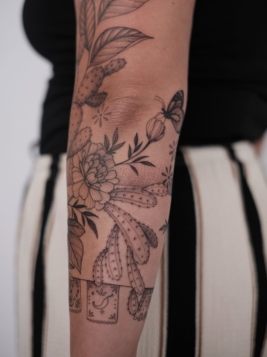 Delicate blackwork cactus and florals with a butterfly.