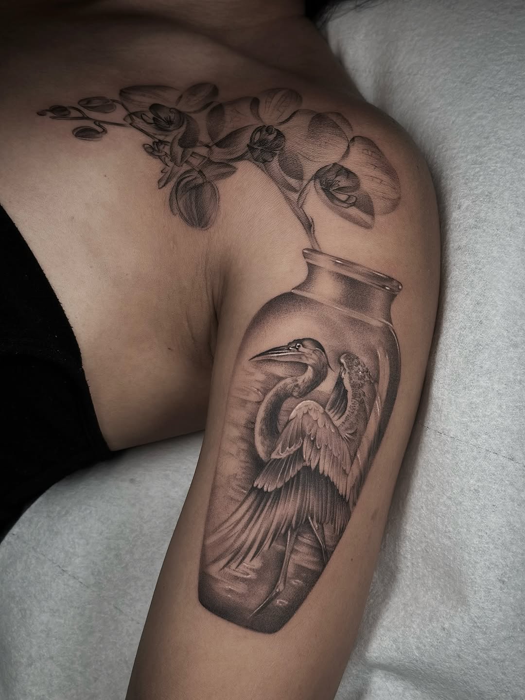 Photorealistic grayscale bottle with a soaring heron
