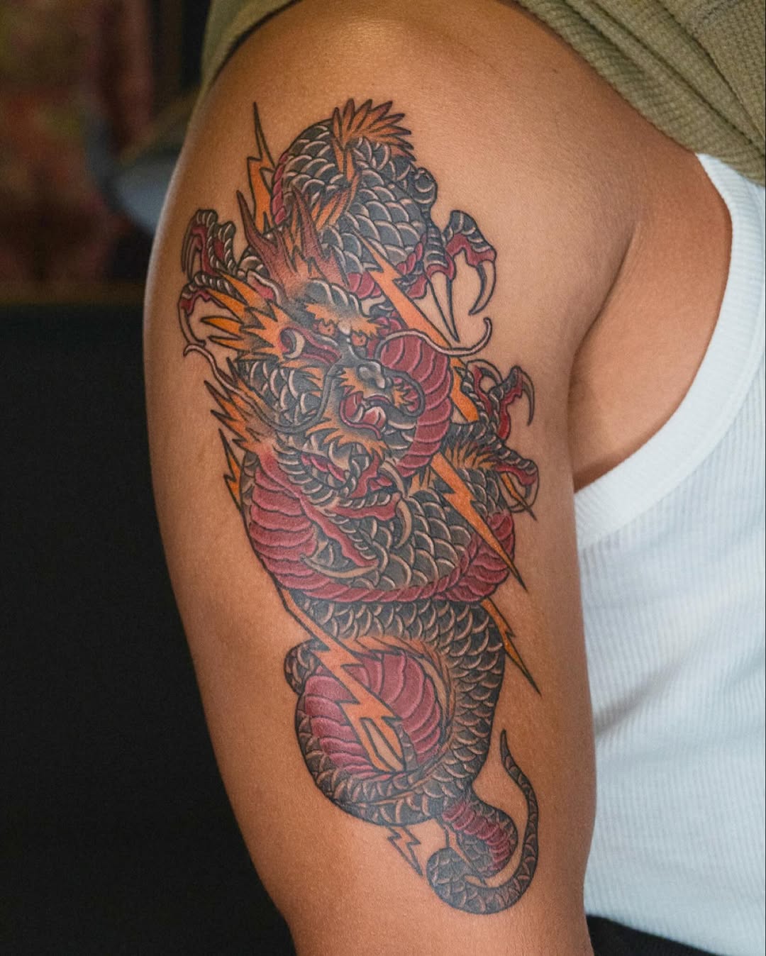 Vibrant neo-traditional dragon with jagged lightning bolts.