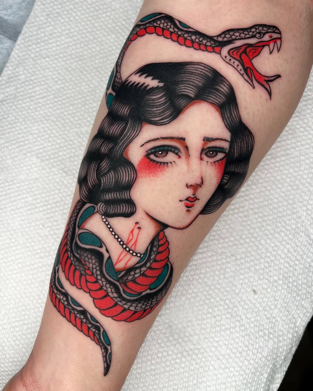 Bold-lined neo-traditional woman portrait entwined by snake.