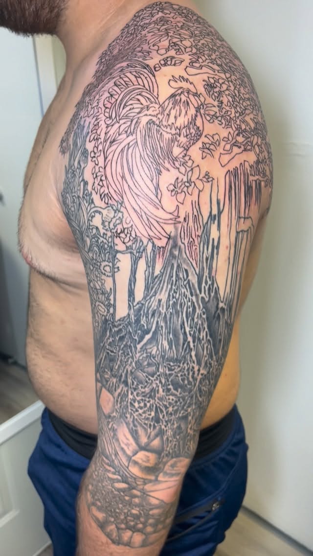 Intricate black-and-gray landscape sleeve with mountains and trees