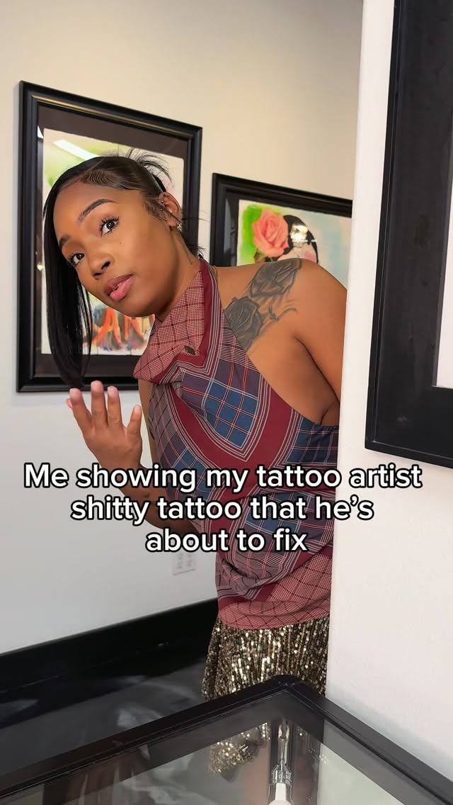 Bold black floral shoulder tattoo with flowing leaves