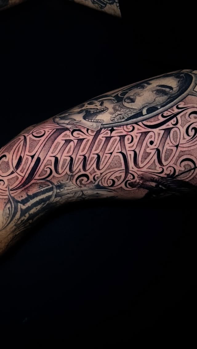 Ornate script lettering with floral swirls and portrait