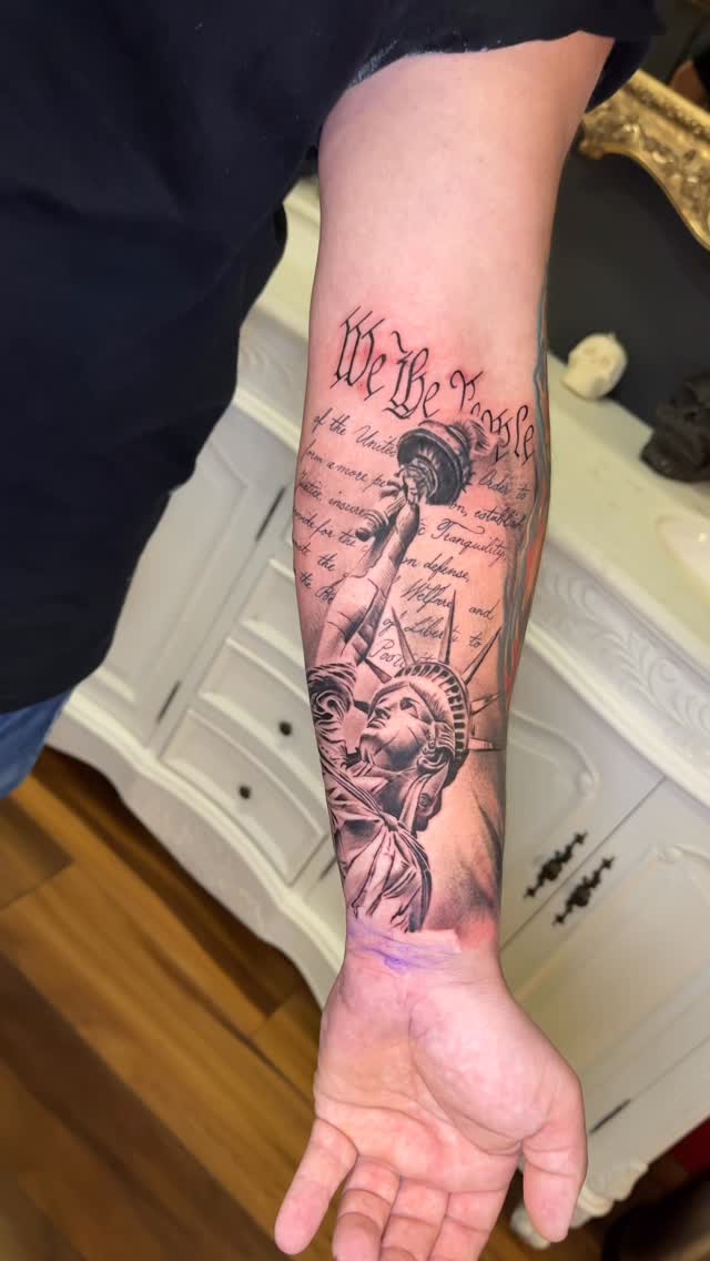 Black-and-gray realism forearm sleeve with Statue of Liberty