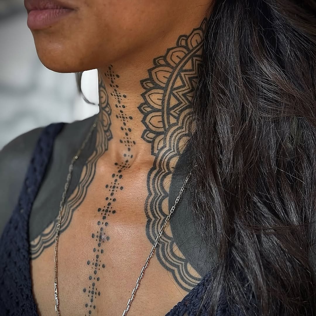 Bold black mandala collar wraps neck with dotted center