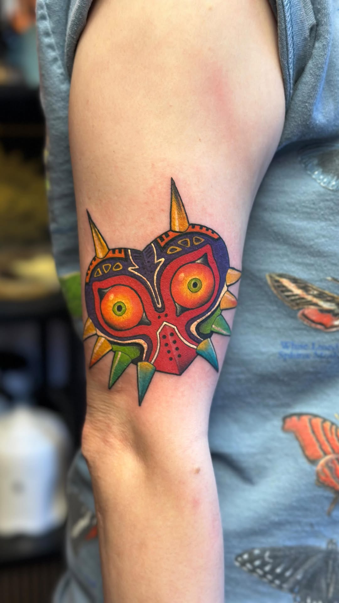 Vivid Majora's Mask-inspired heart-shaped face, bold colorwork