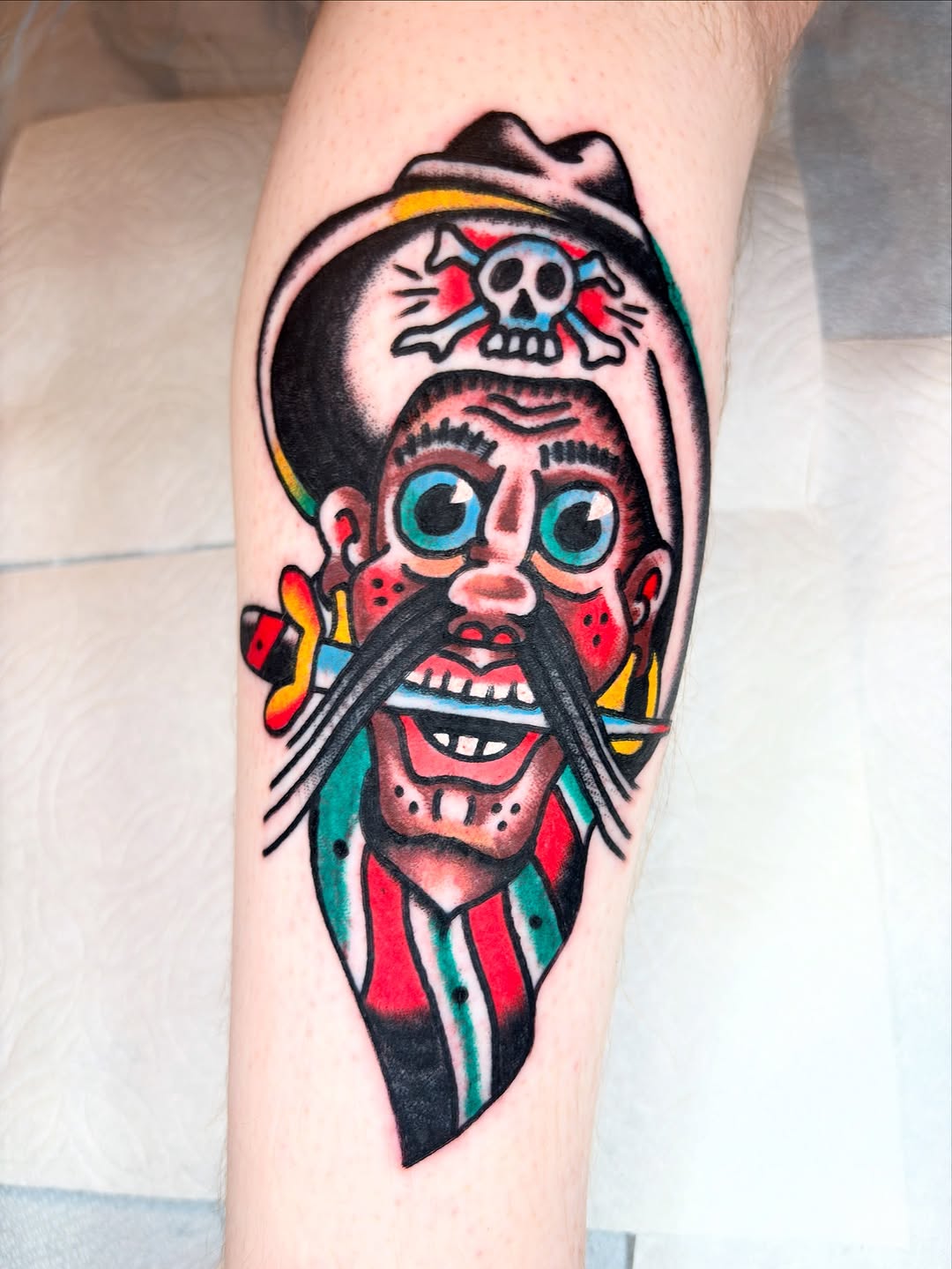 Bold traditional sailor portrait with skull-on-hat motif