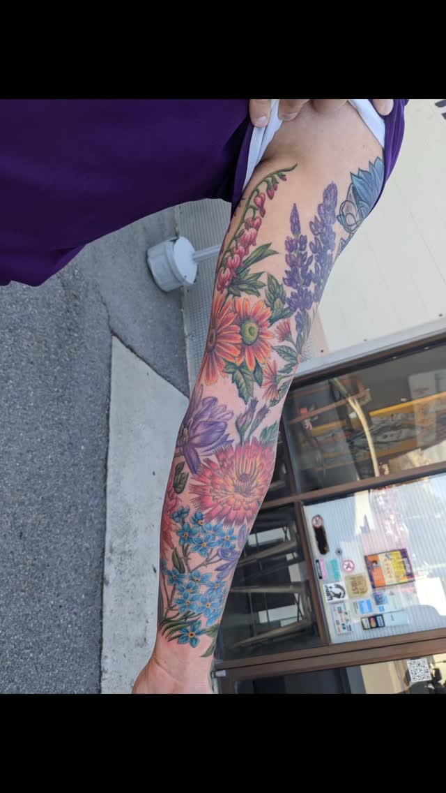 Vibrant floral sleeve with bold petals and foliage