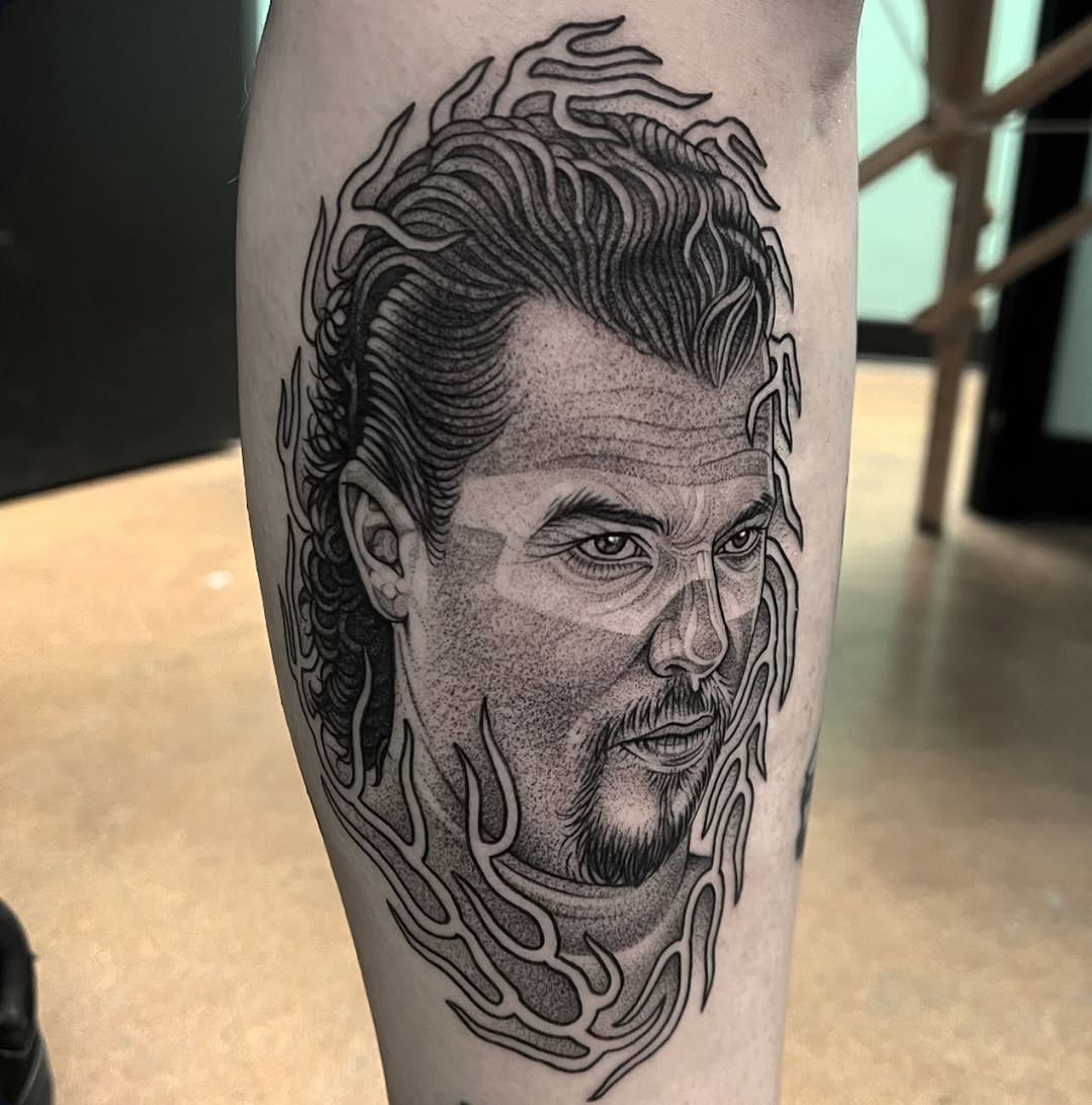 Bold blackwork portrait framed by flame-like curves.