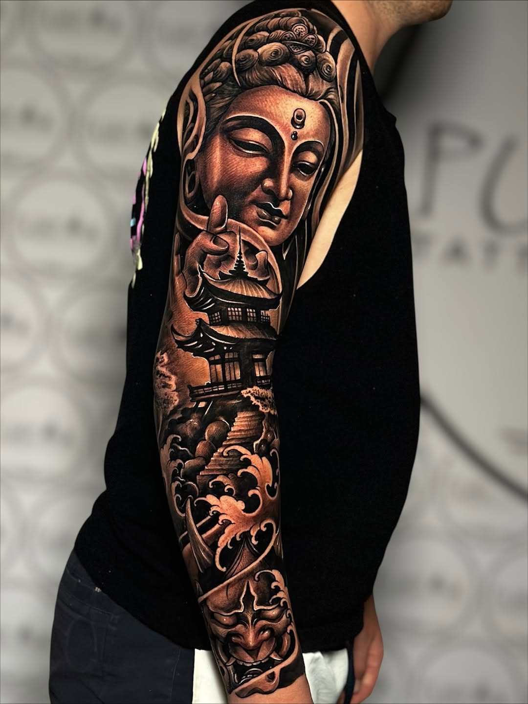 Japanese-inspired black-and-gray Buddha sleeve with temple and waves