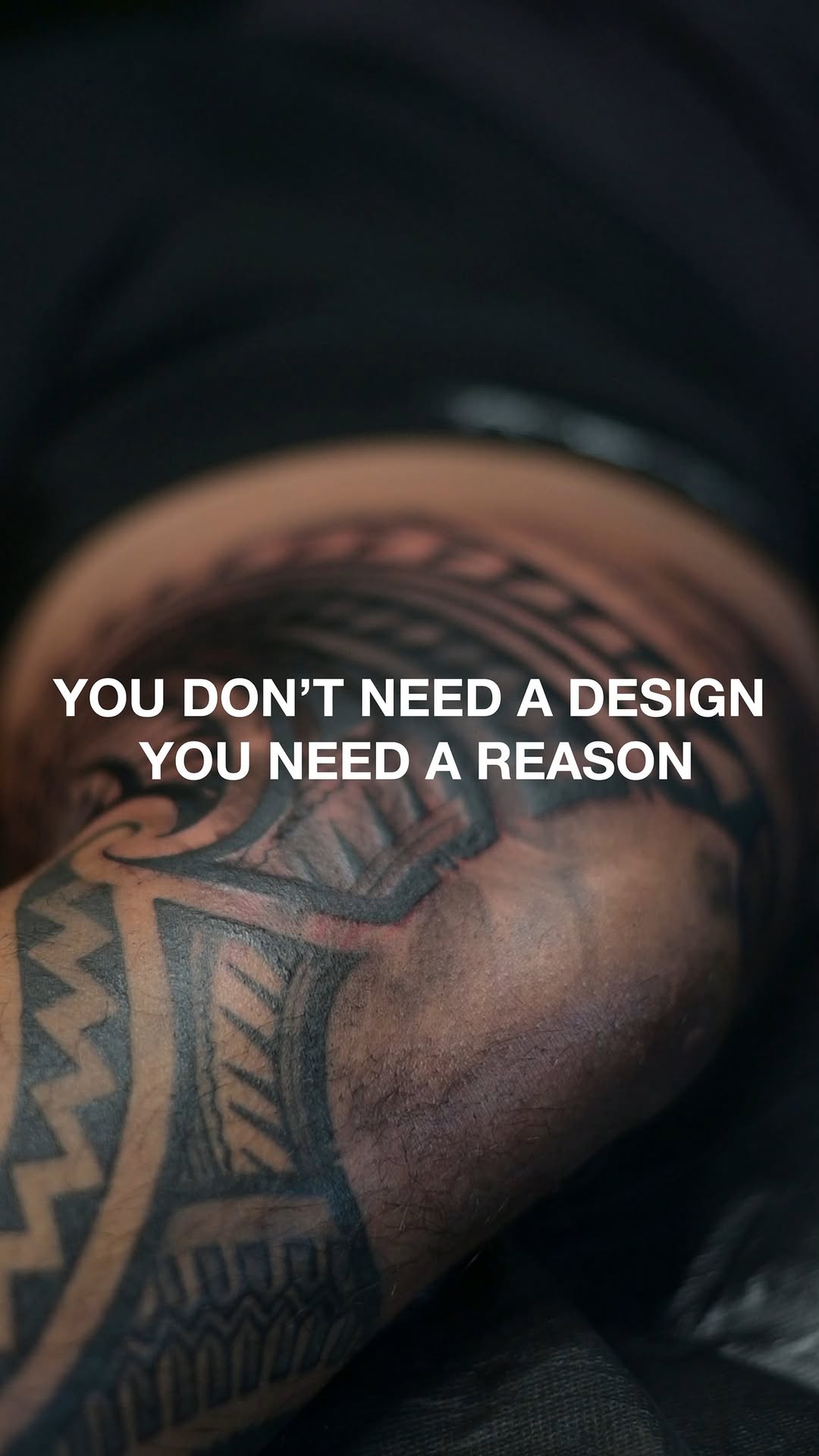 Bold black geometric tribal forearm tattoo with zigzags