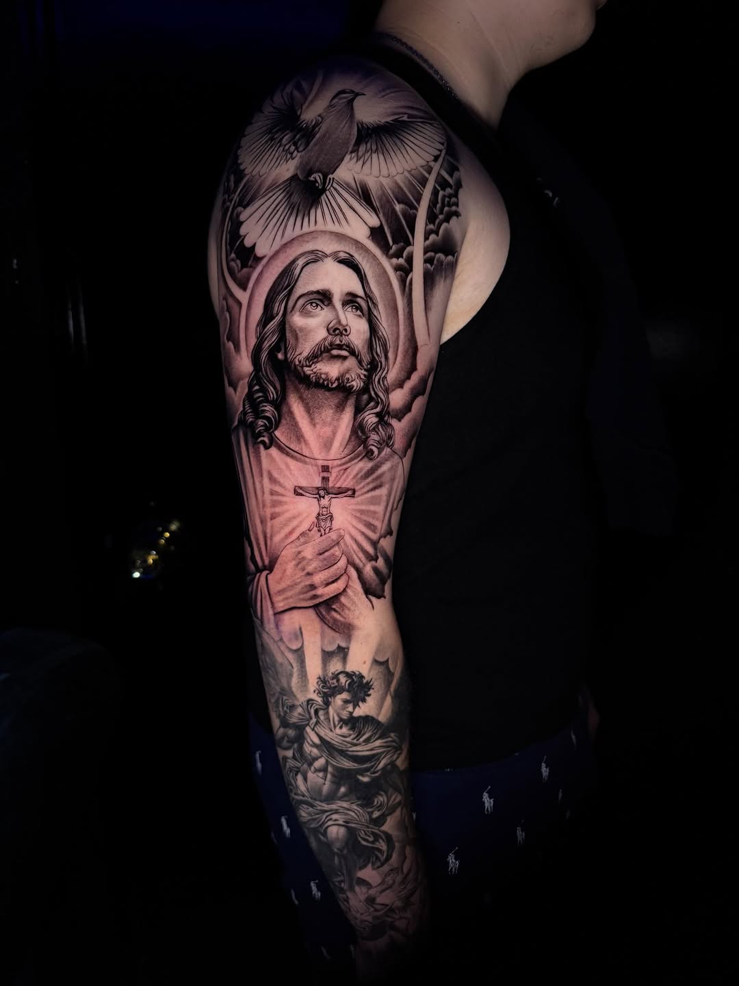 Dramatic black-and-gray Jesus portrait with halo and cross