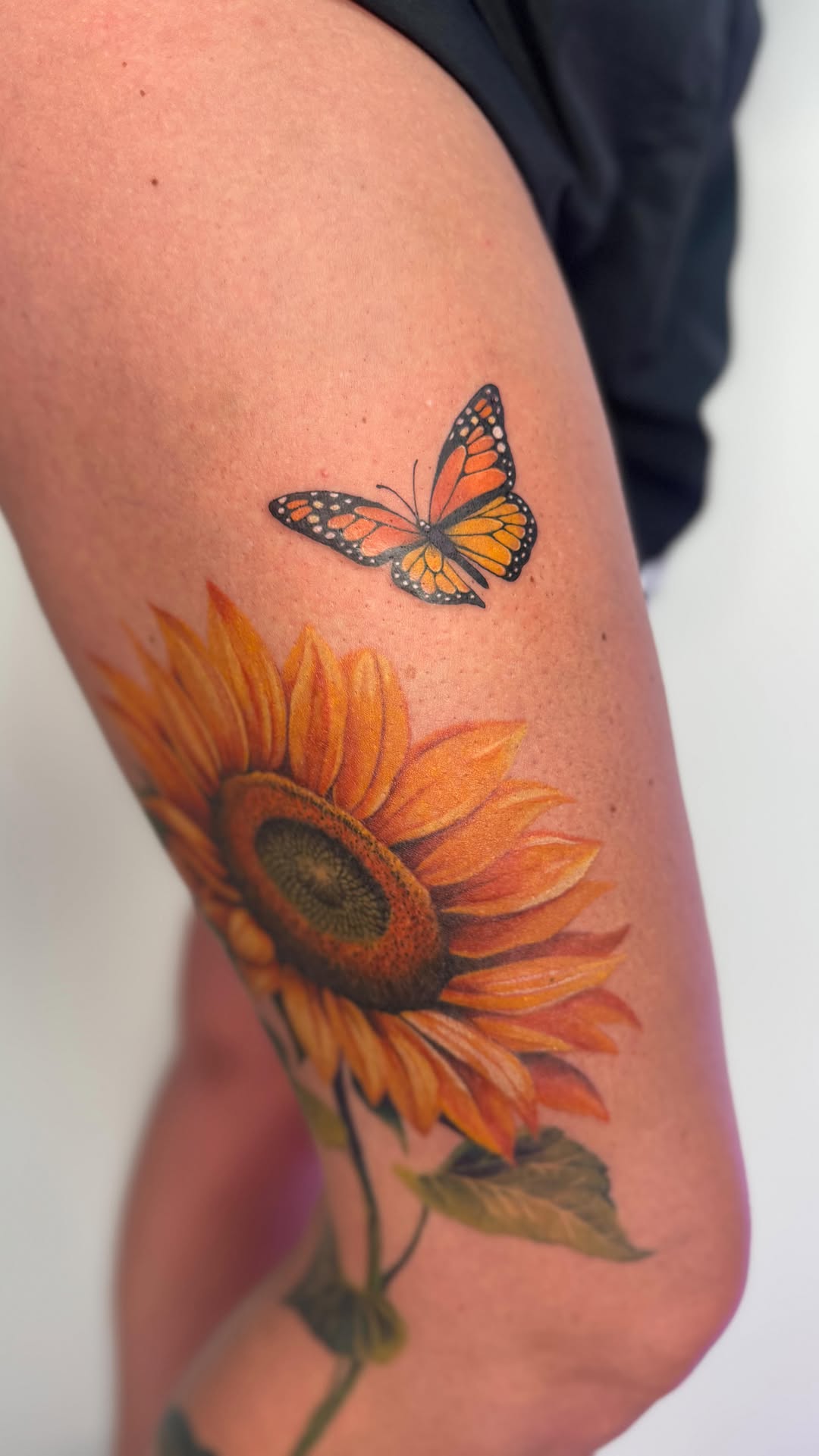 Vibrant sunflower with a delicate butterfly, lifelike.