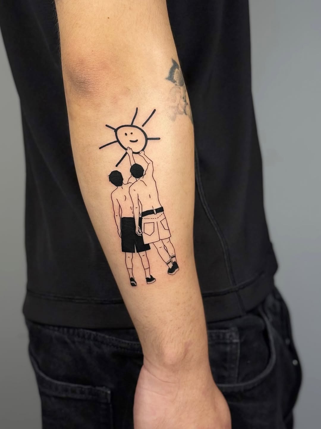 Two shirtless men lift a smiling sun in bold linework.