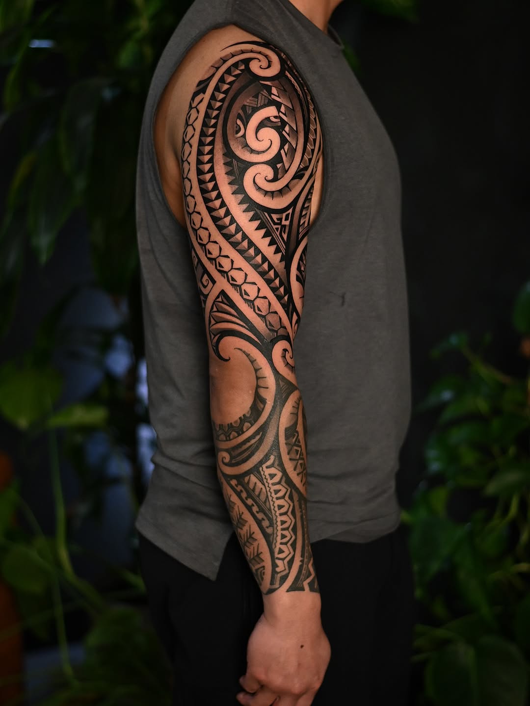 Bold Polynesian tribal blackwork sleeve with geometric motifs