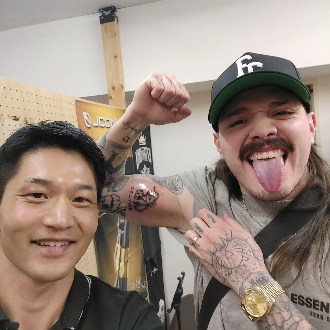 Energetic forearm tattoos with bold black linework.