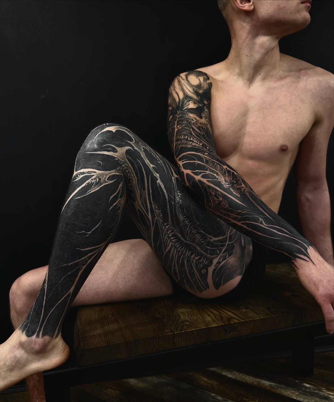 Intense blackwork sleeves with sculpted negative-space details
