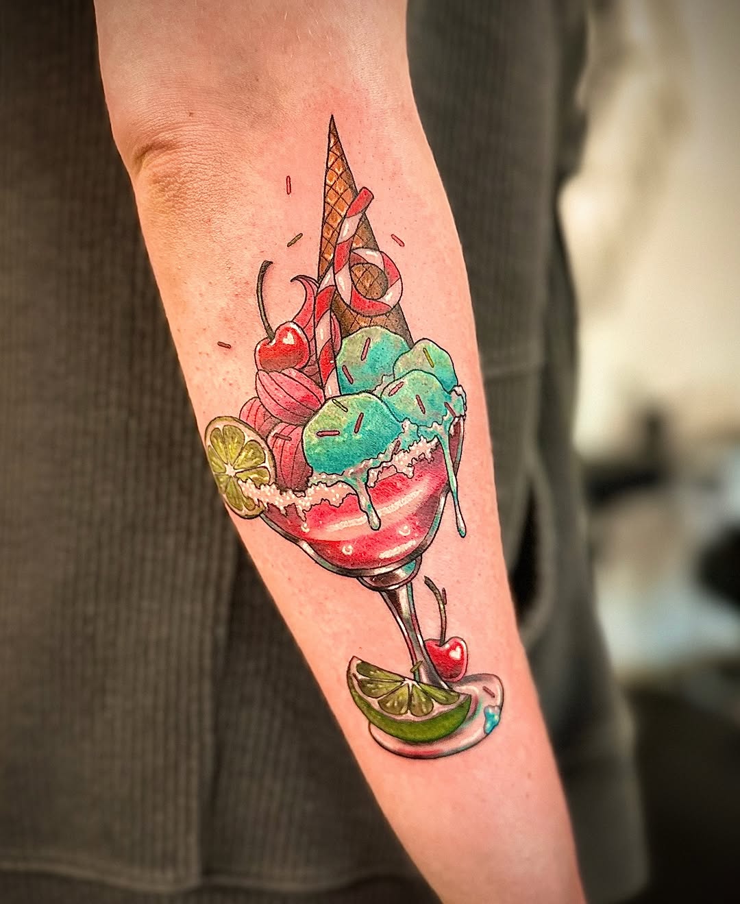 Bright, whimsical ice-cream sundae tattoo with dripping scoops.