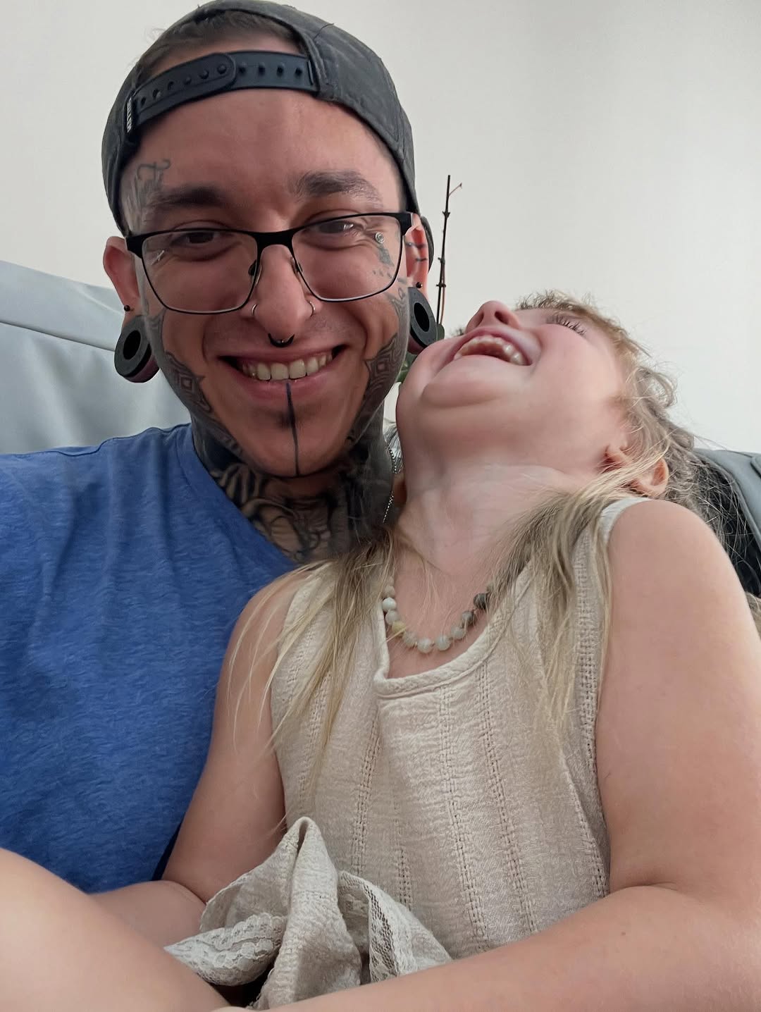 Bold geometric blackwork face tattoos with neck accents.