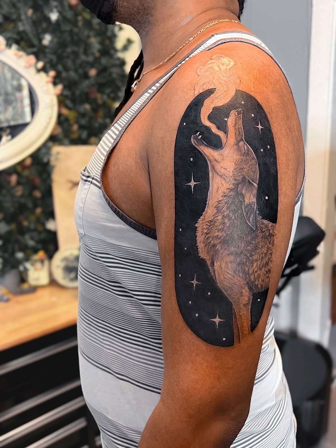 Howling coyote silhouette in a cosmic black circle, stars