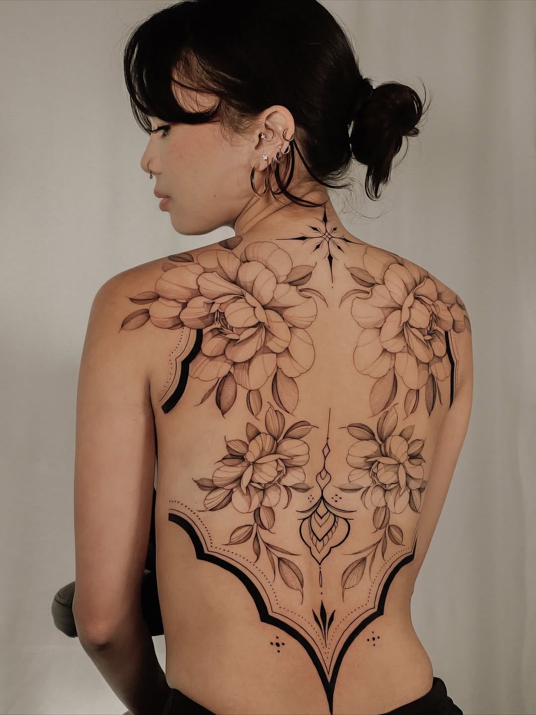 Elegant black-and-gray floral back piece with ornate linework