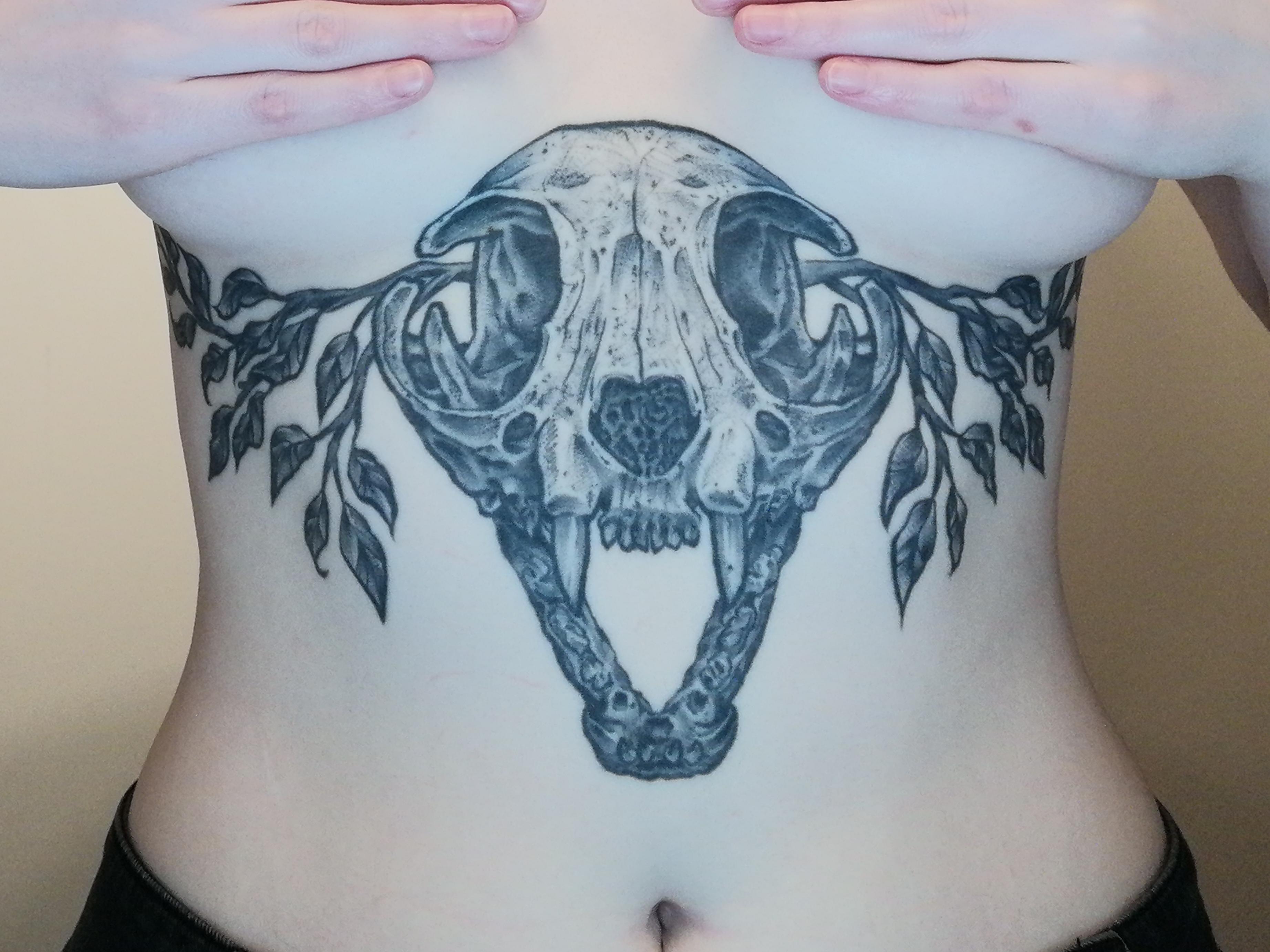 Bold blackwork skull with entwined leafy vines