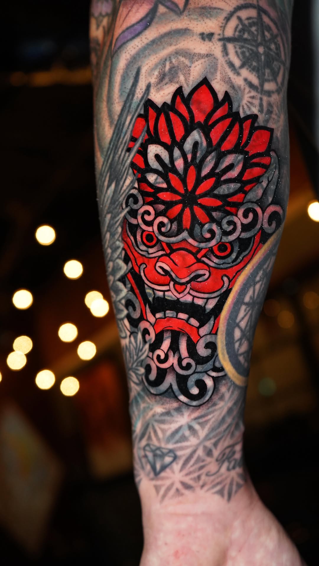 Bold neo-traditional foo dog over a lotus blossom