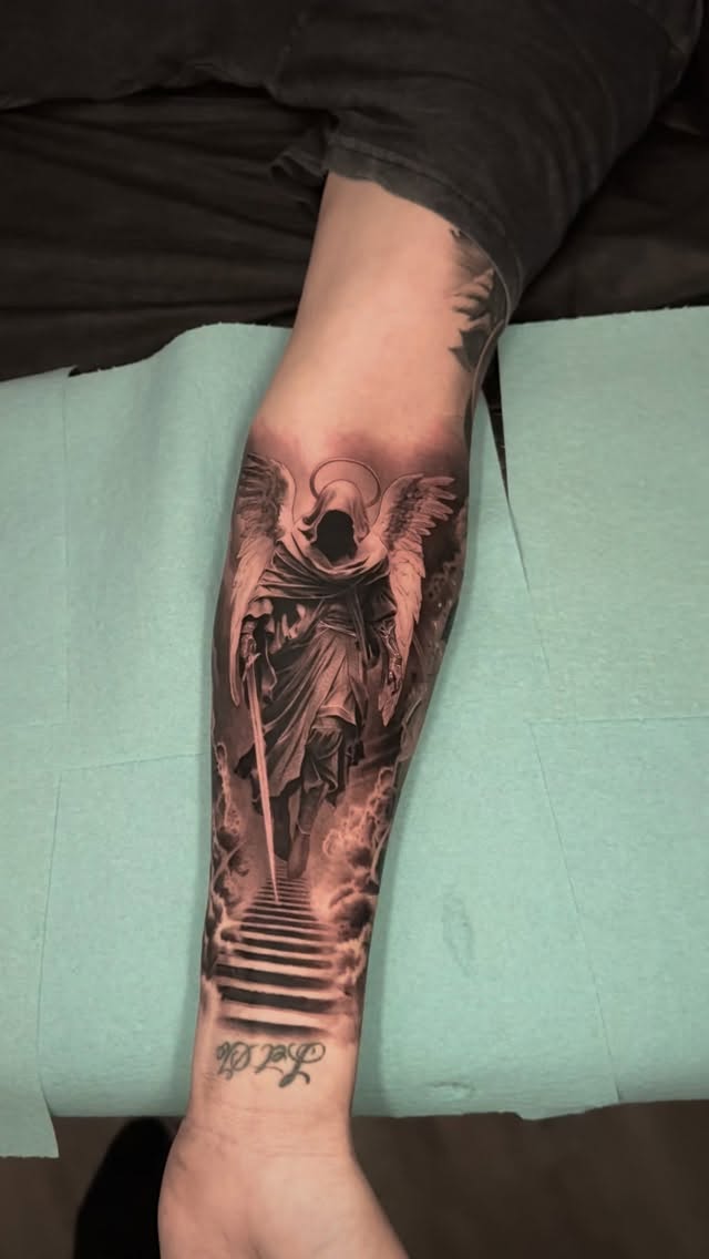 Dramatic black-and-gray angel with wings and stairway