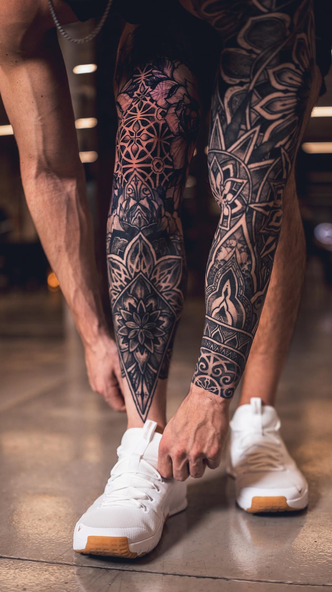Intricate blackwork leg sleeve with geometric floral motifs
