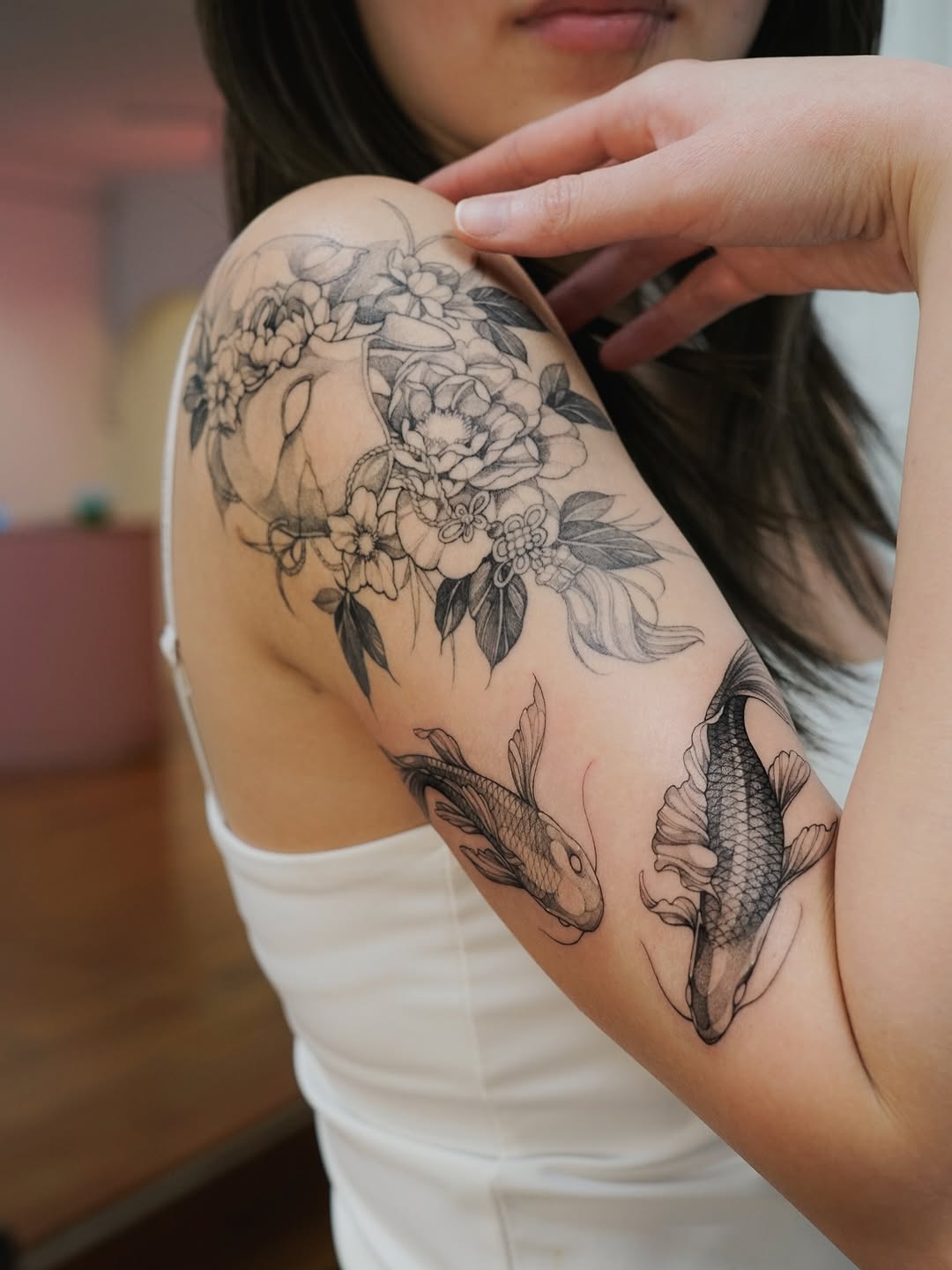 Intricate floral and koi composition in fine-line blackwork