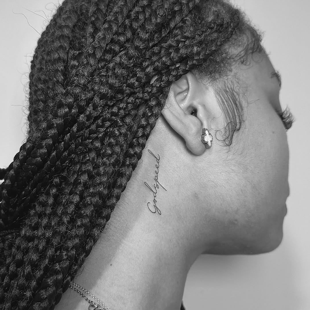 Elegant cursive 'Godspeed' neck script with delicate lines.