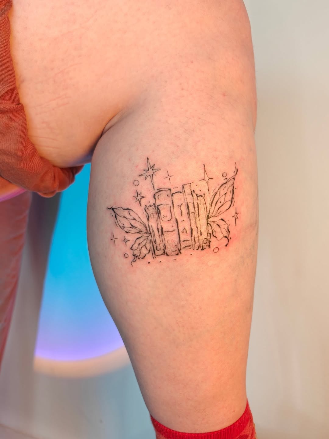 Delicate stack of books with leaves and stars.