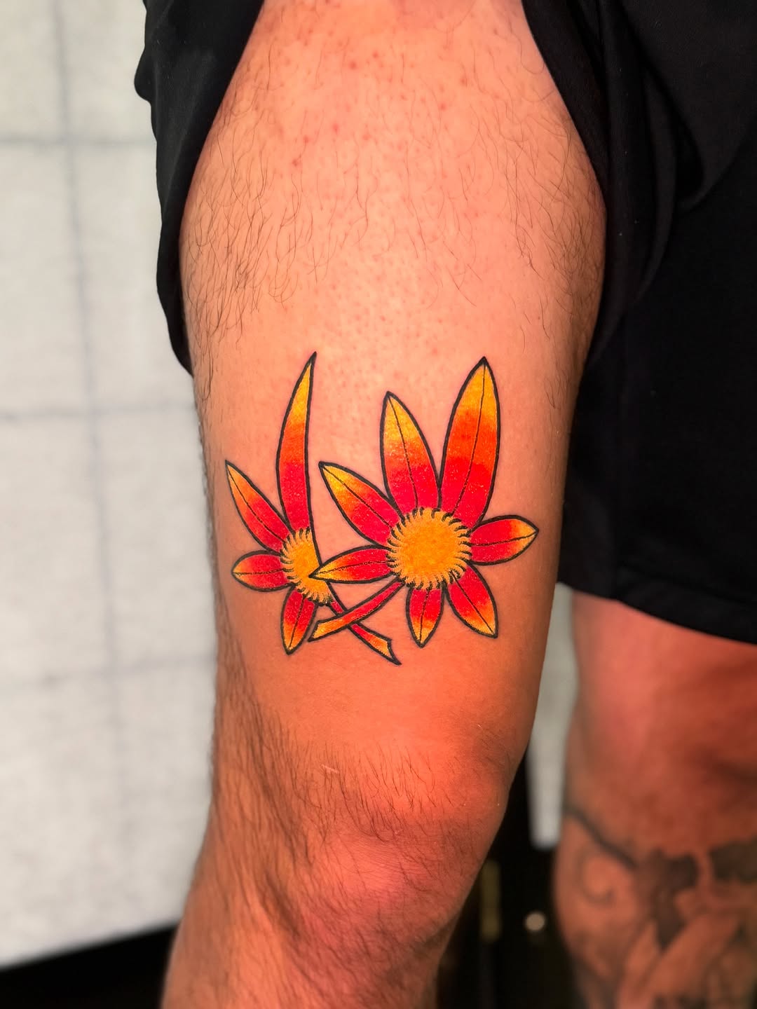 Bold orange daisies with black outlines in neo-traditional style.