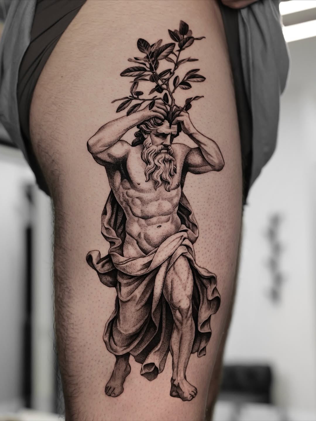 Bearded mythic god with sapling crown, dramatic black-gray shading.
