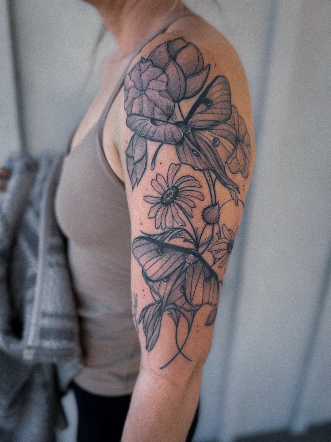 Bold blackwork floral sleeve with a delicate butterfly