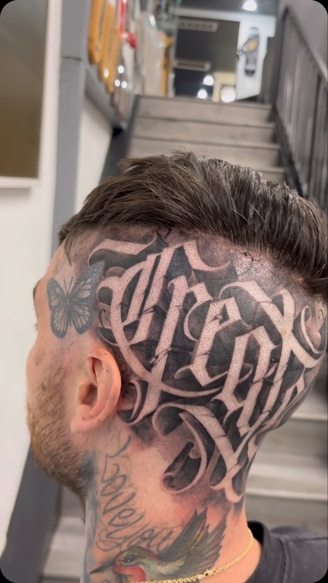 Massive black-gray scalp script with butterfly and bird accents