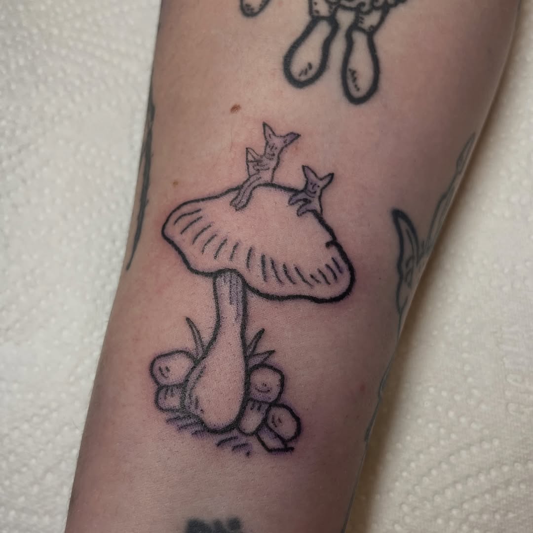 Whimsical hand-poked mushroom with tiny goblin sprites