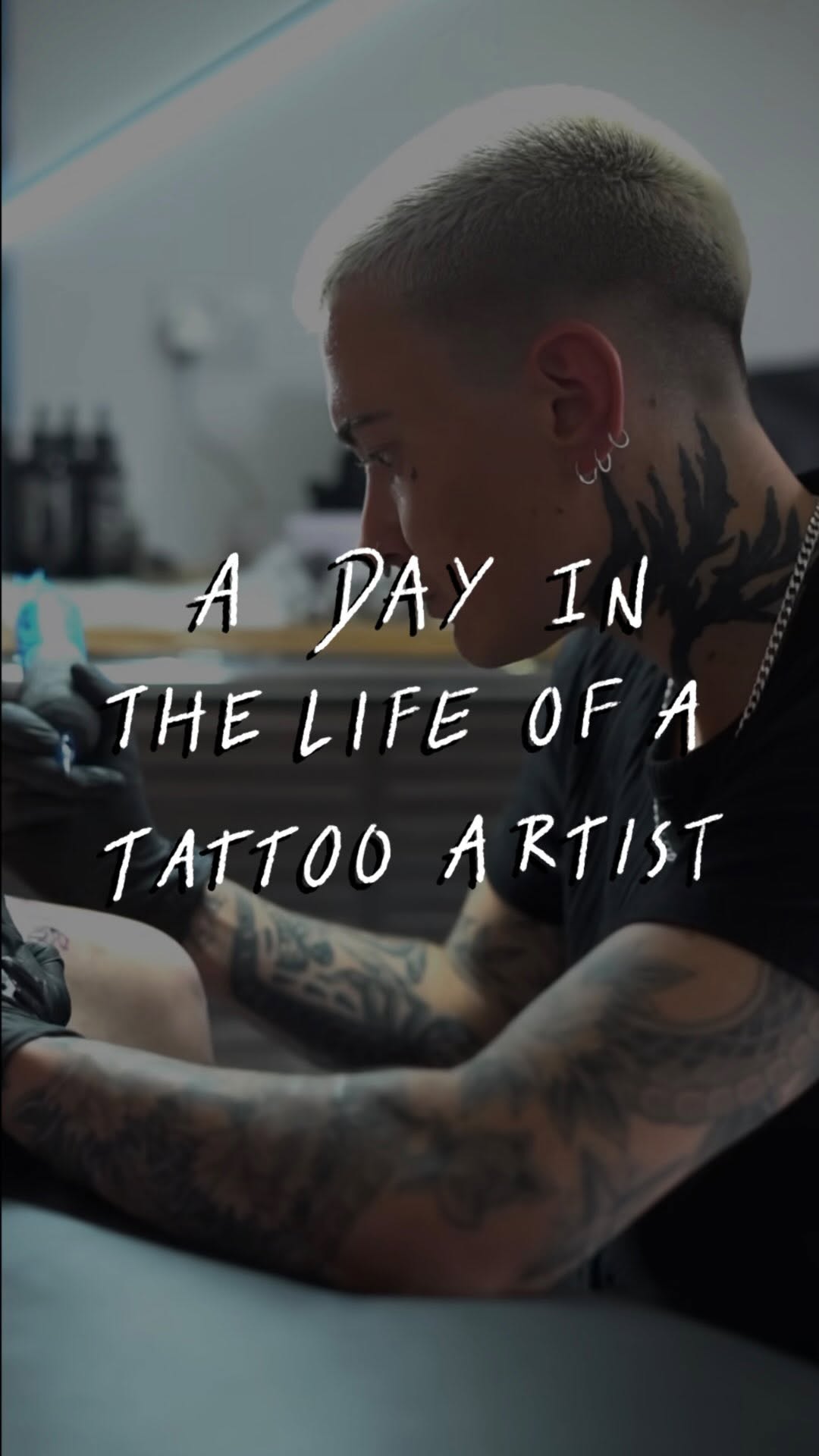 Focused tattoo artist inking in a moody studio setting