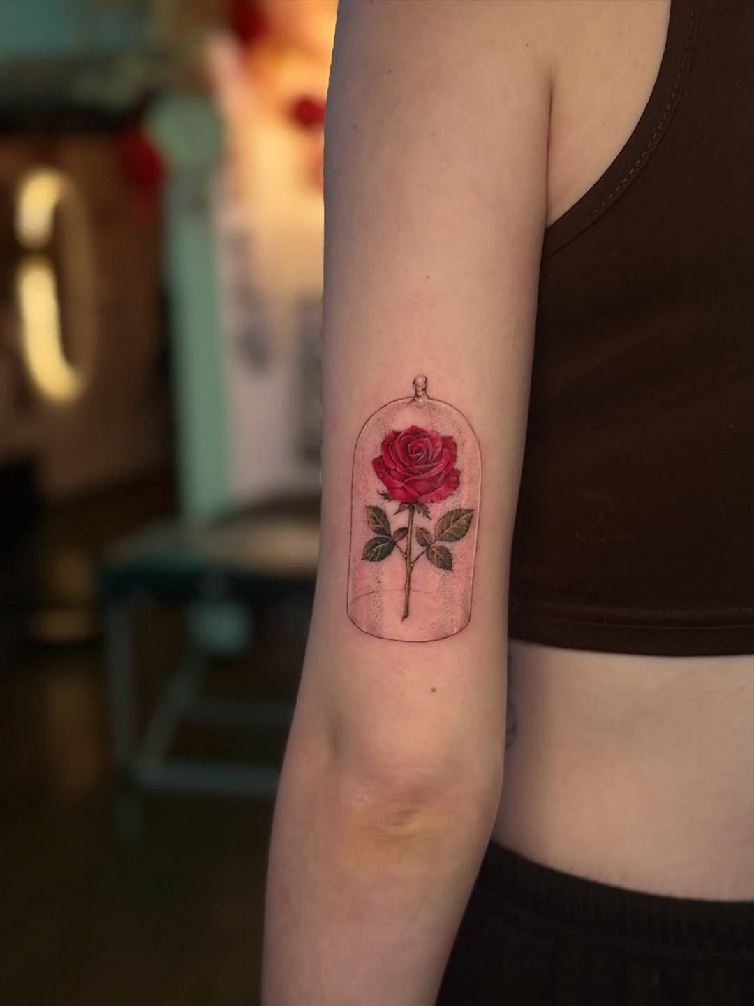 Vibrant red rose encased in a delicate glass cloche