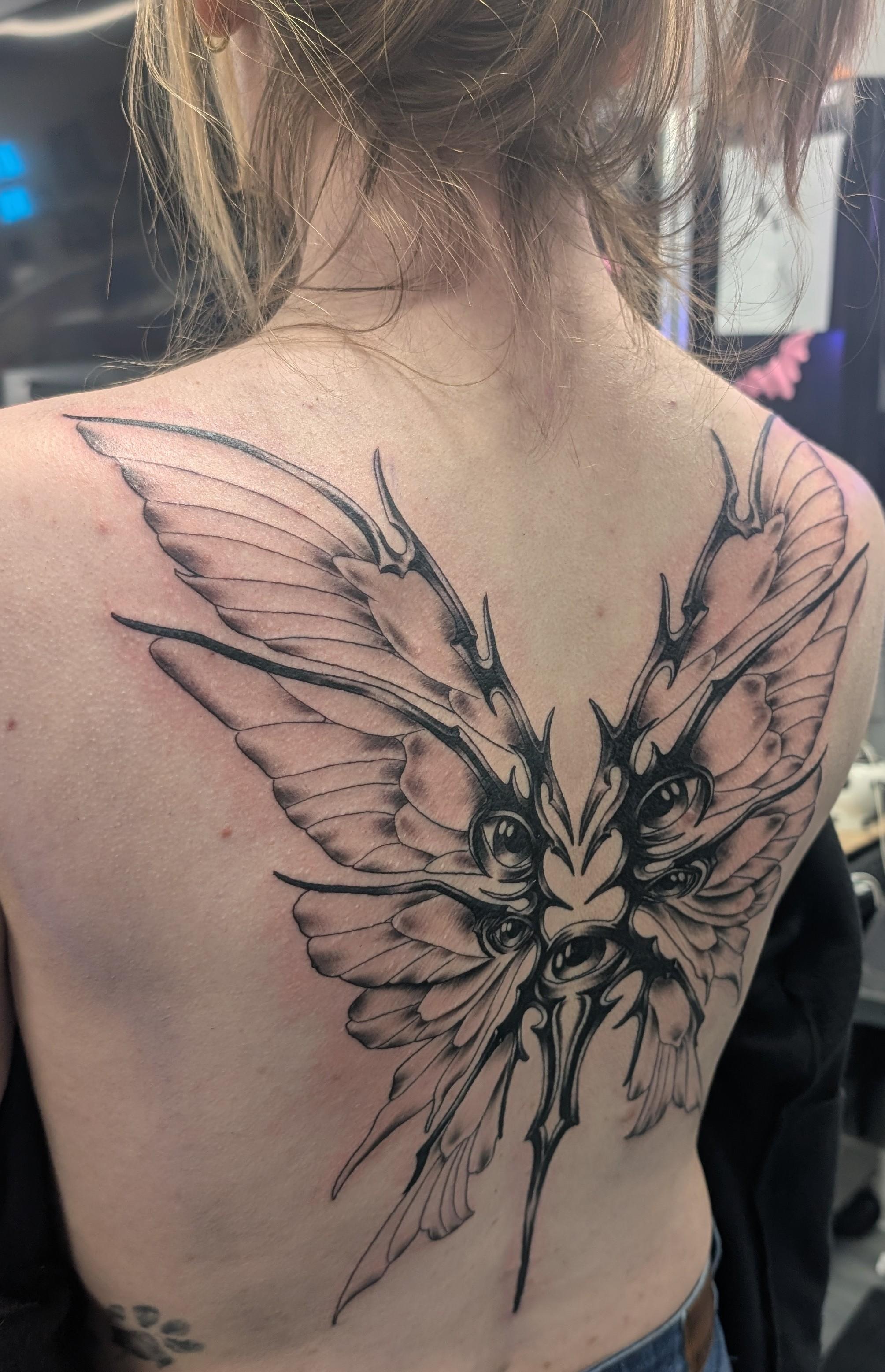 Lovecraftian butterfly with spiky central thorax and eerie eye cluster