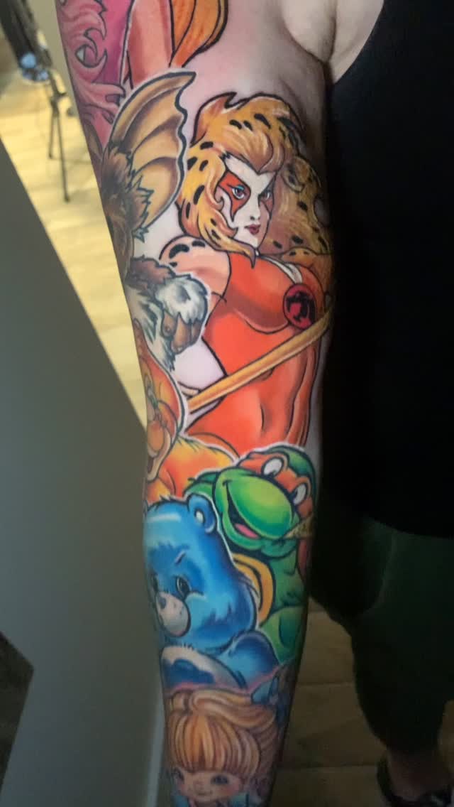 Vibrant neo-traditional sleeve of 80s cartoon icons