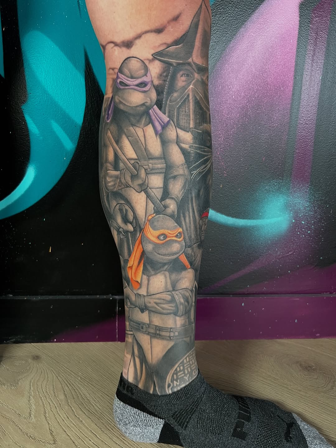 Hyper-detailed grayscale TMNT leg sleeve with orange-masked turtle