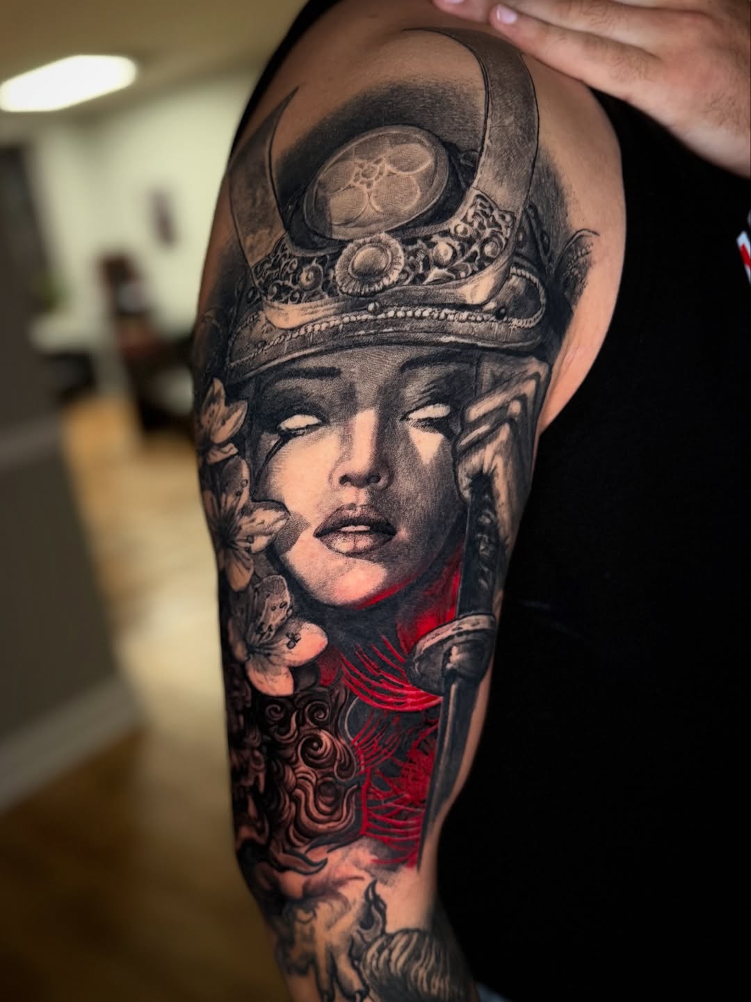 Monochrome regal female face with crown, dagger, florals