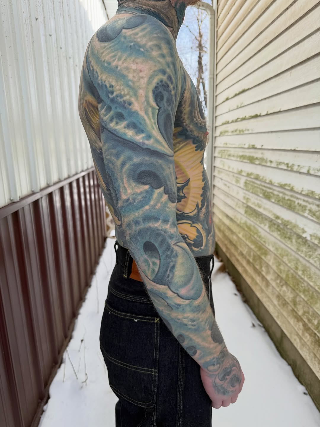 Textured biomechanical sleeve in blue-gray waves and gears.