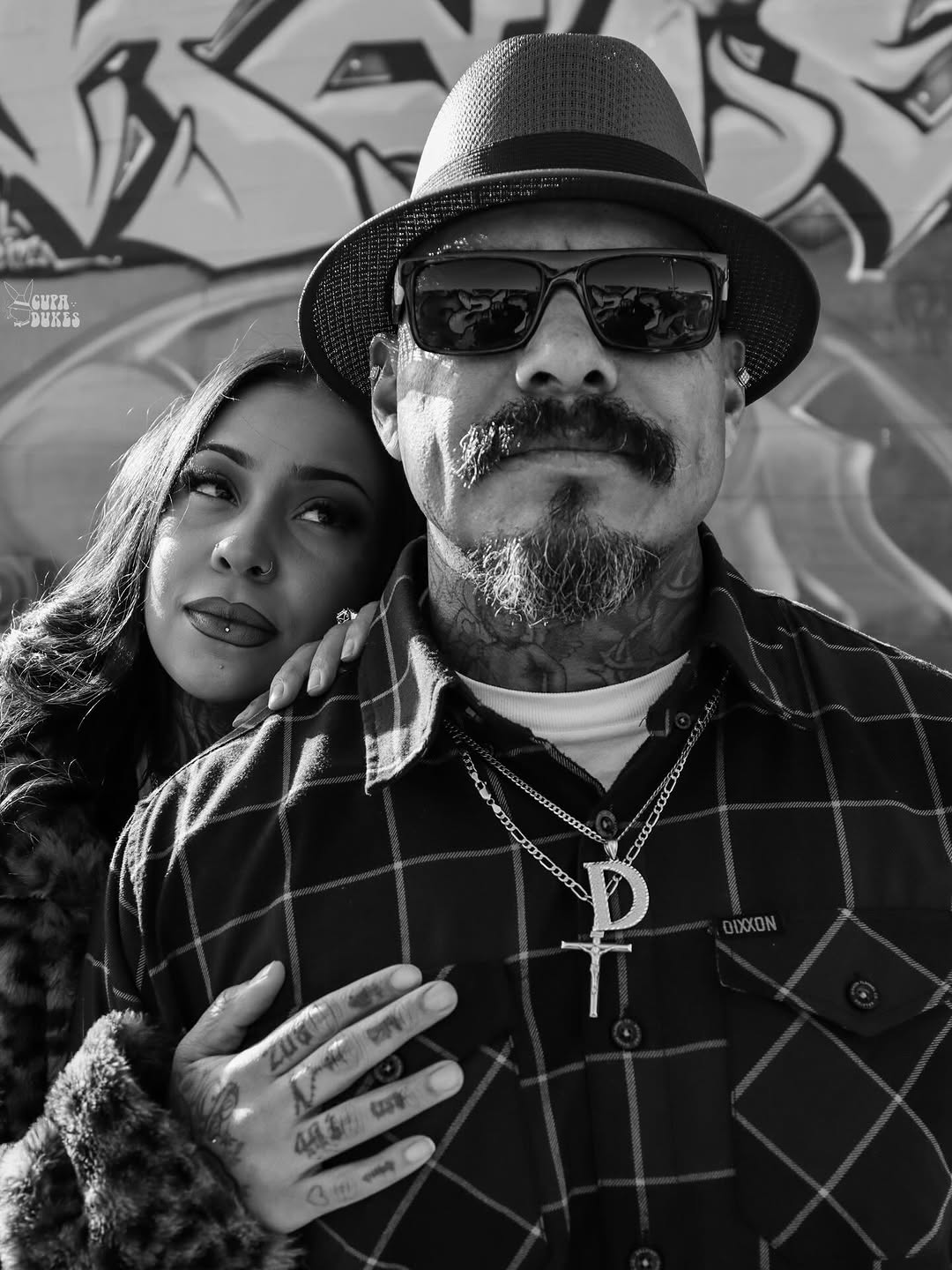 Bold black-and-gray neck ink and finger tattoos