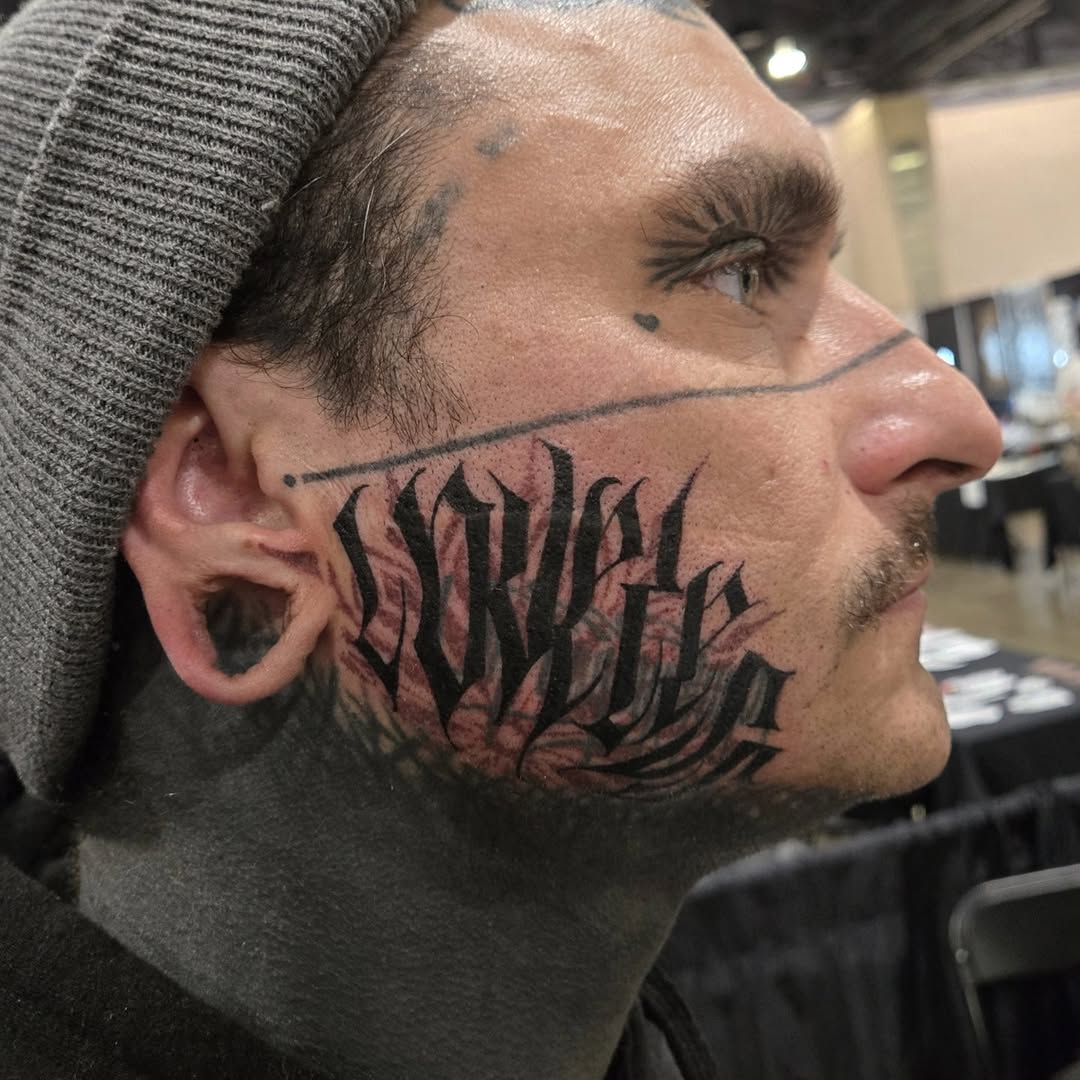 Bold blackletter 'Loveless' script across cheekbone, dramatic