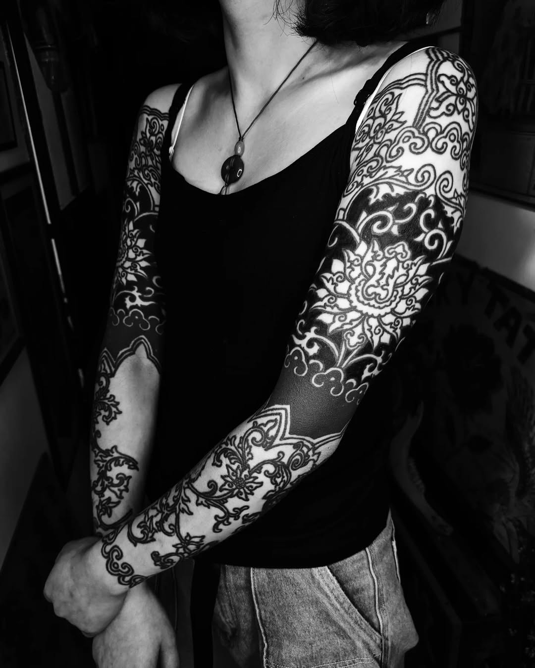 Intricate blackwork ornamental sleeve with swirling floral filigree