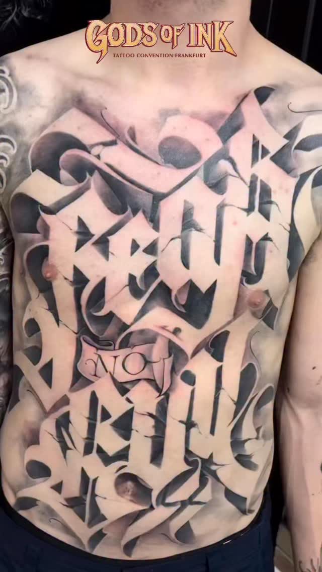 Monumental black-and-gray ornamental graffiti-script chest piece
